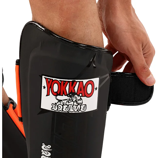 Защитные накладки на ноги
 Муай Тай, ММА, Кикбоксинг кожаная YOKKAO BO-5032 (Черный-оранжевый)